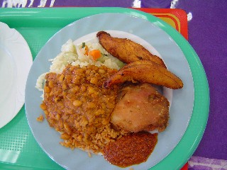 Lunch of rice, red red, chicken and fried plantains